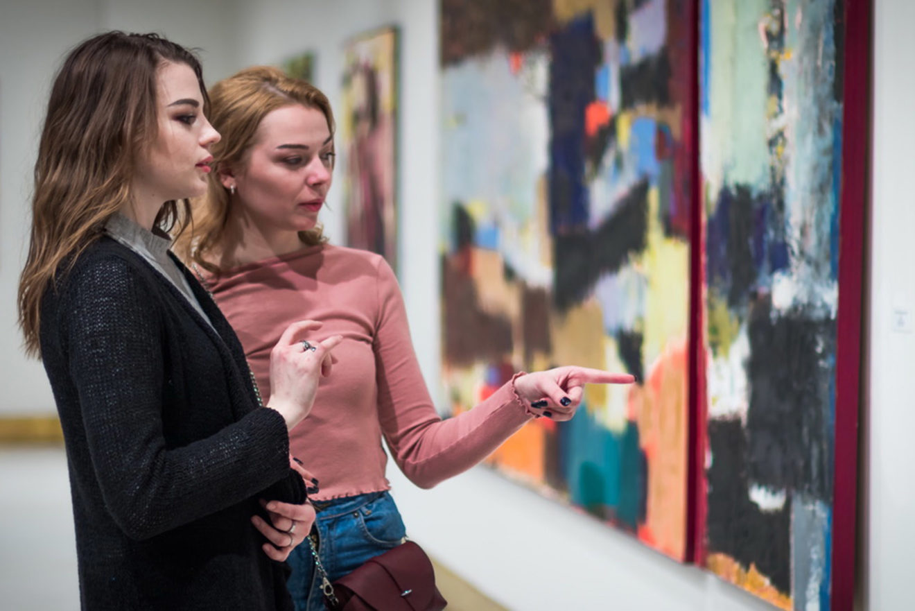 two girls discuss paintings in Gallery of modern art